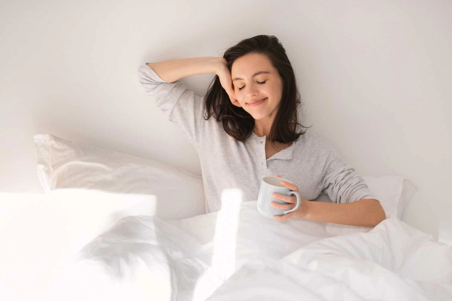 Woman enjoying a peaceful morning routine to show how to break the cycle of morning anxiety ?naturally