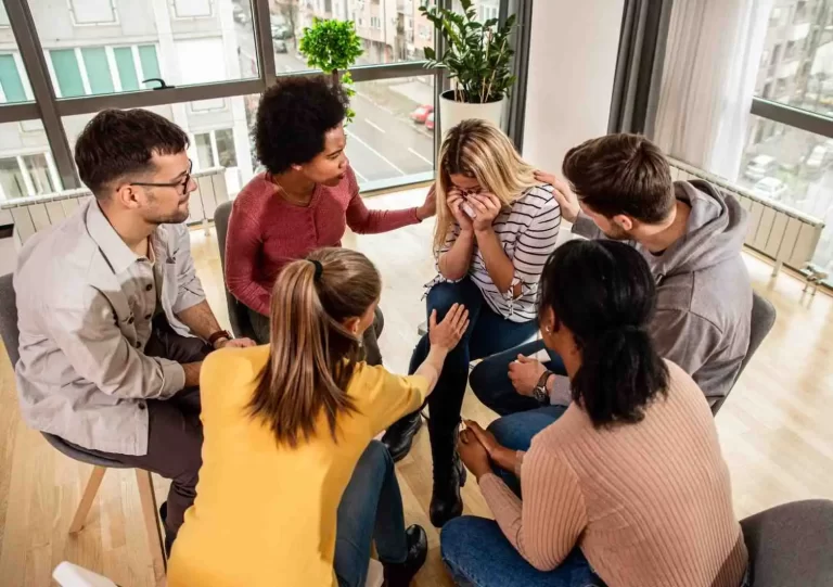 Group Therapy For Anxiety session with diverse adults sitting in a circle providing peer support in therapy