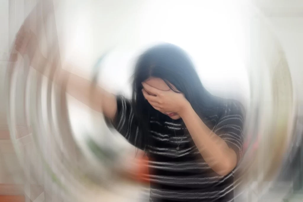 Person experiencing emotional distress and dizziness representing what does it mean when someone is spiralling mentally