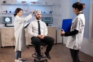 What Is Neuropsychiatric Testing? Patient undergoing brain wave monitoring during clinical neuropsychiatric evaluation in medical office