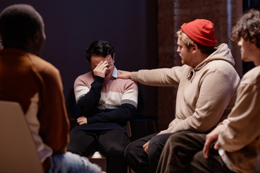 Types Dissociative Disorders support group session with a distressed individual receiving emotional support