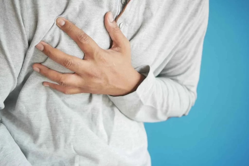 Why Does Anxiety Cause Chest Pain? person holding chest due to anxiety-related discomfort