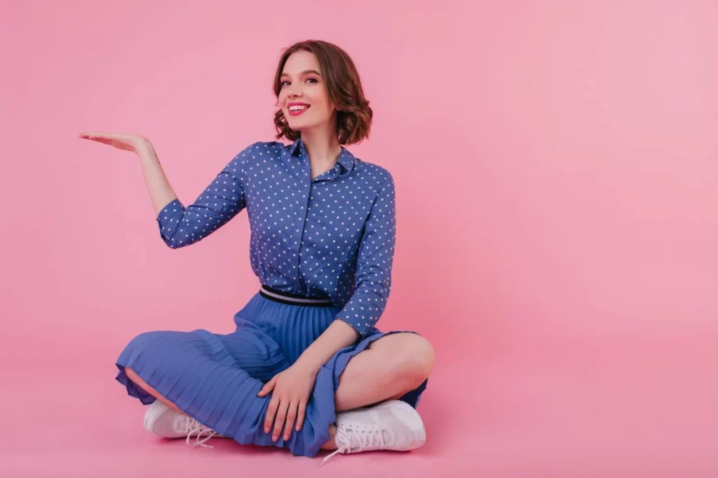 Woman sitting confidently and gesturing calmly, representing how to set healthy boundaries, emotional boundaries, and assertive communication skills in daily life