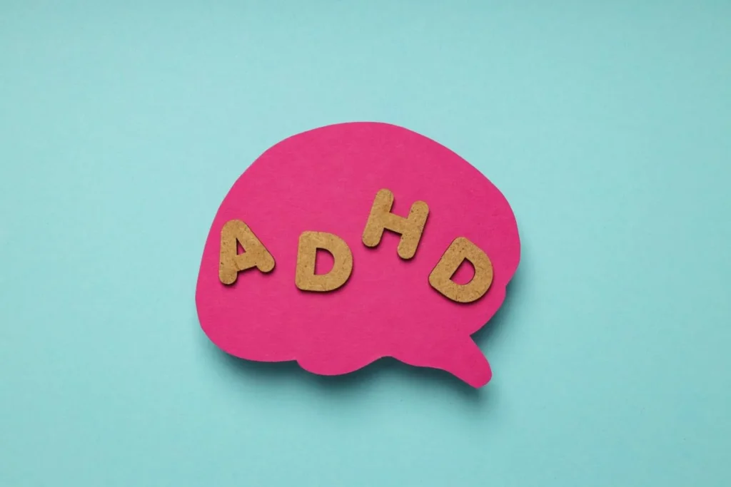 Difference Between ADHD And ADD concept showing ADHD letters inside a brain illustration representing attention deficit hyperactivity disorder and inattentive ADHD symptoms